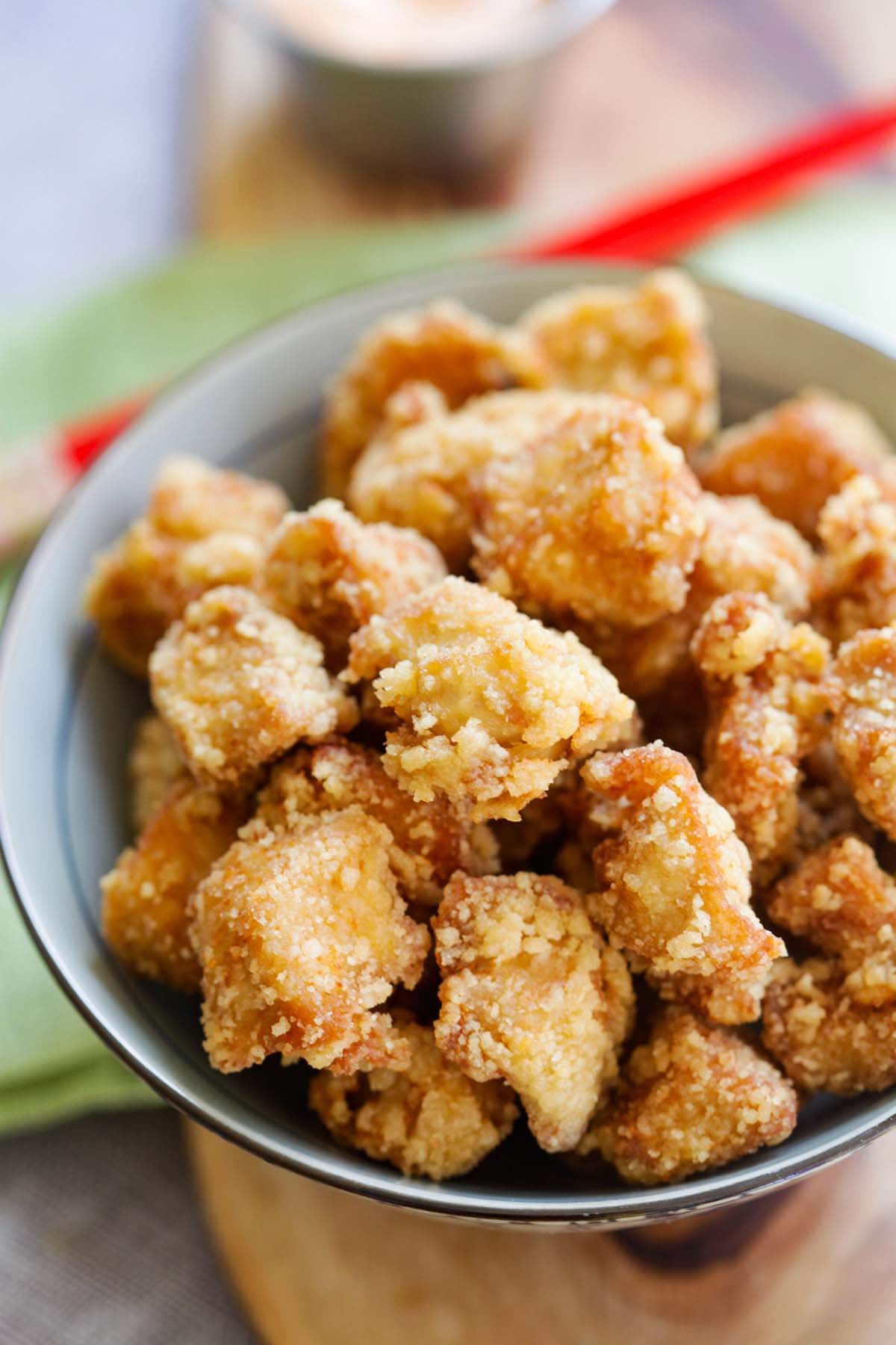 Fried Japanese marinated chicken with golden-brown crispy exterior and  succulent texture of chicken highlighted. 