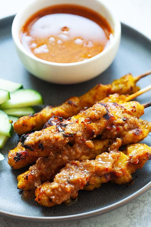 Chicken satay skewers coated with satay sauce.