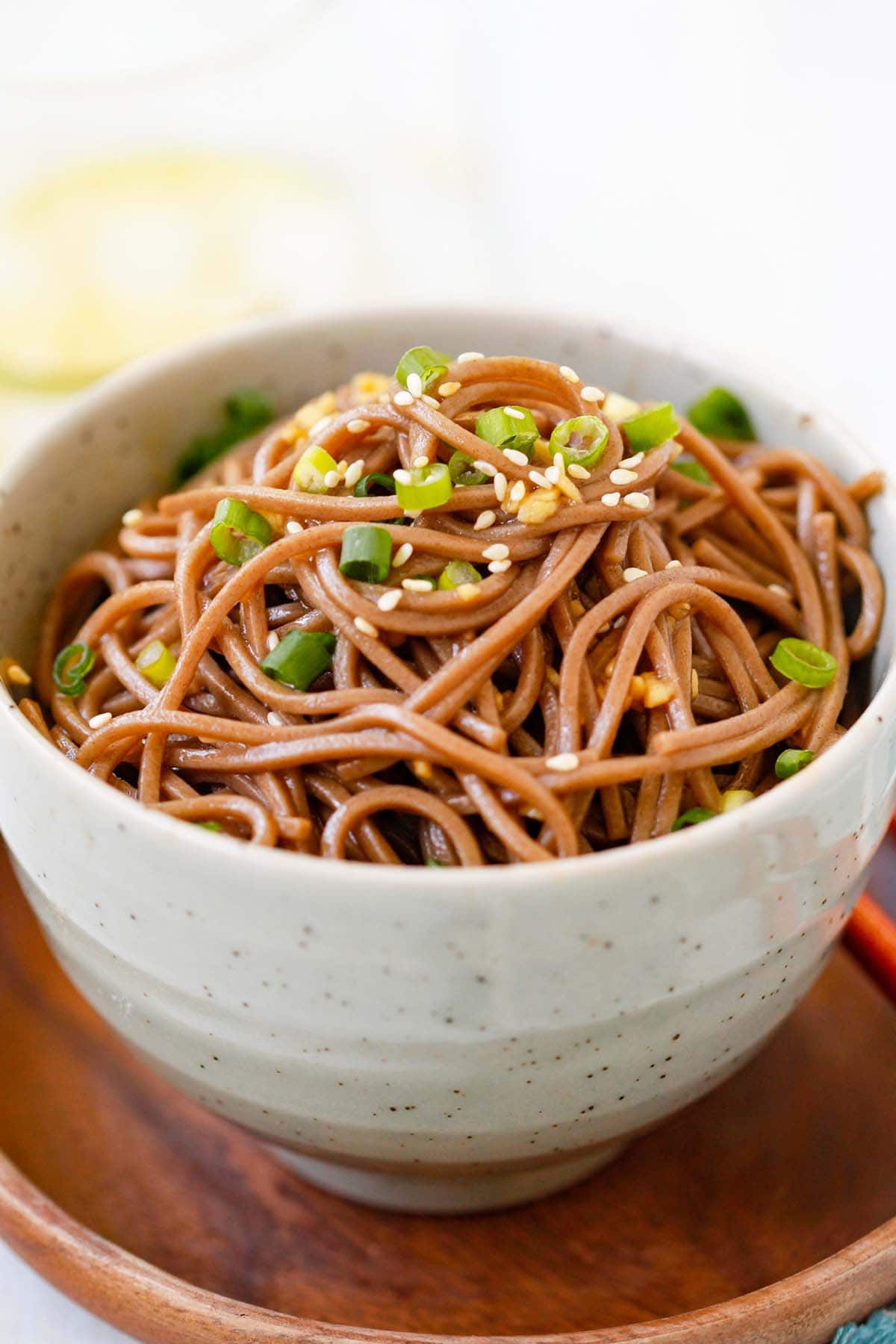 Homemade easy noodles made with ginger, soy sauce, honey and Japanese soba noodles ready to serve.